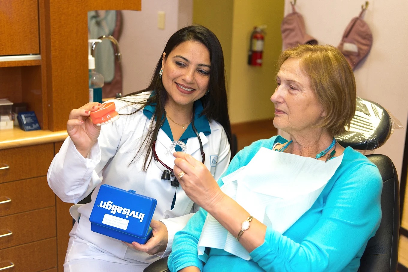 Dr. Saboowala showing a patient her Invisalign aligners