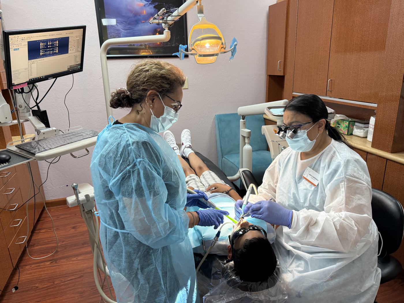 Dr. Saboowala and her assistant treating a patient
