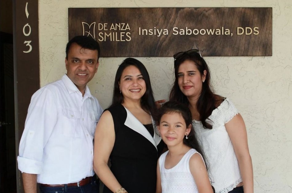 A family with Dr. Saboowala outside De Anza Smiles